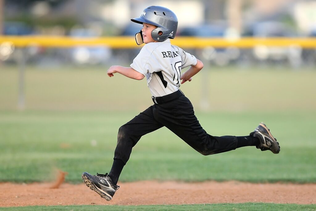 A child runs the bases on a baseball diamond