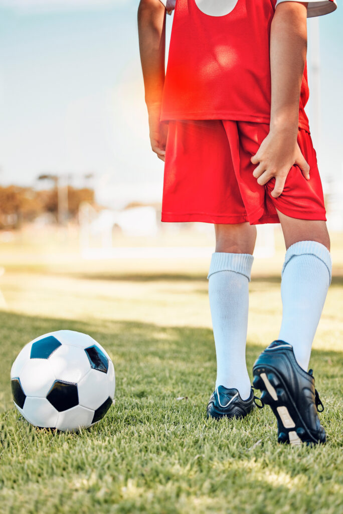 A soccer player feels a hamstring injury.