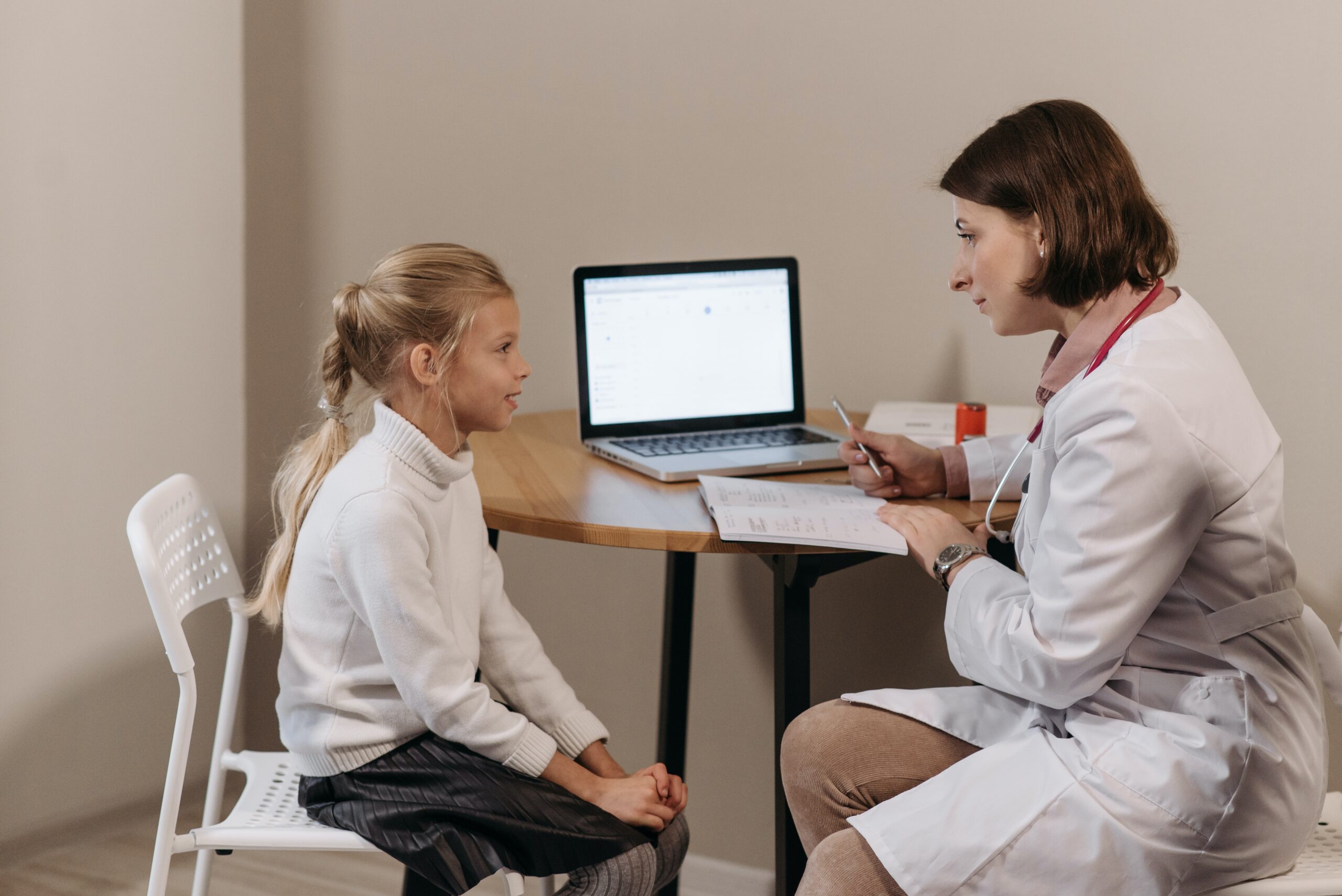 A child speaks with their doctor about their limping problems.