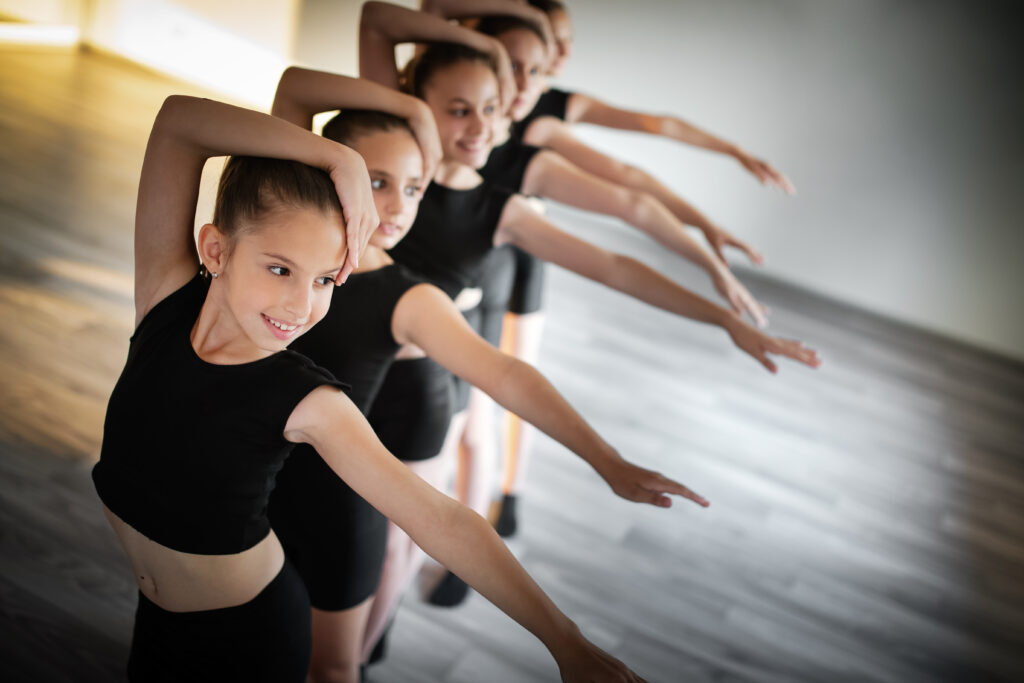 Group of children dancing and ballet in studio together