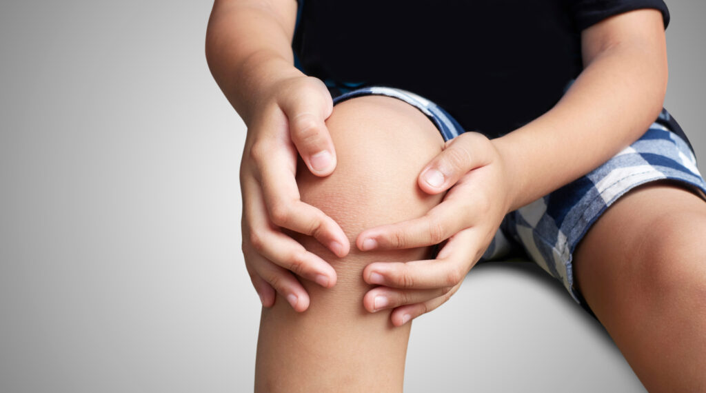 kid with knee pain, isolated background